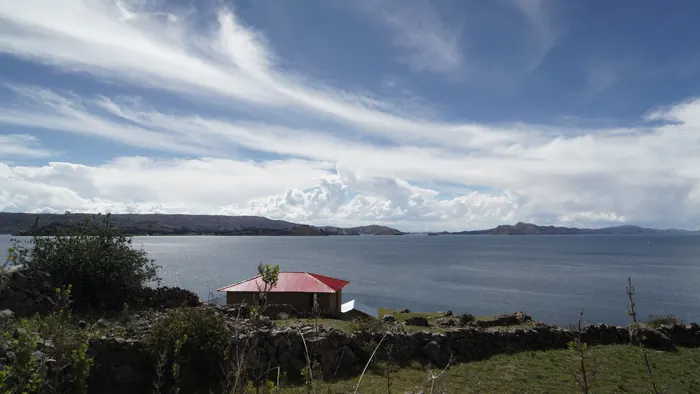 Stone path leading to the island arch with Lake Titicaca behind
