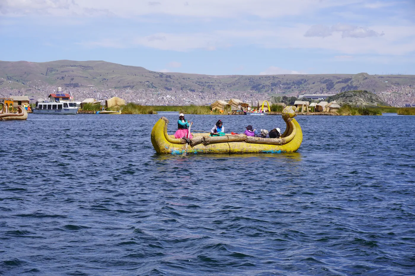 A reed boat crossing between the islets