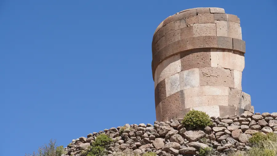 Stone chullpa at Sillustani against the blue altiplano sky