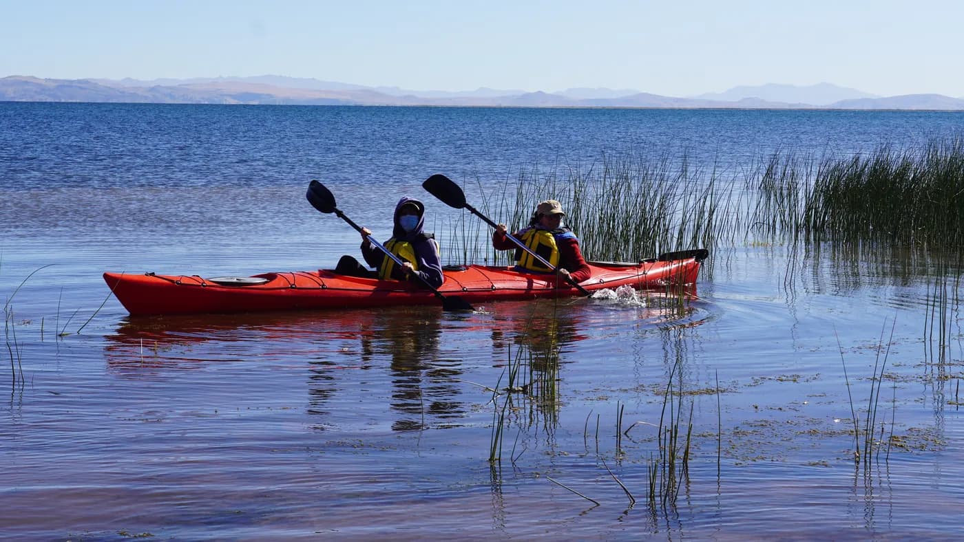 Tandem kayak paddling through the reed beds of Lake Titicaca